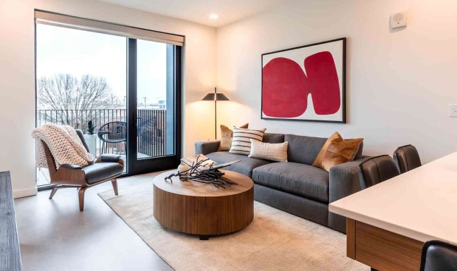 living room with furniture art and large windows